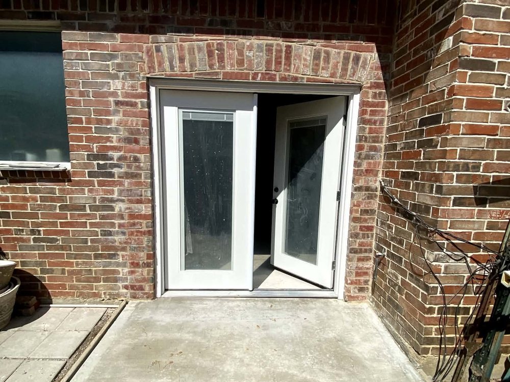 A finished enclosed room with new French doors where an open patio used to be